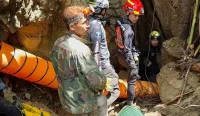 Tim penyelamat bersiaga di pintu masuk gua banjir di Provinsi Xaysomboun, Laos, untuk mengevakuasi warga yang terjebak.