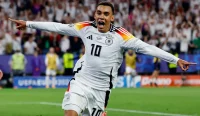 Jamal Musiala merayakan gol untuk Jerman saat menghadapi Denmark di Euro 2024, menjadi andalan dalam Prediksi Jerman vs Curacao pada laga Grup E Piala Dunia 2026.