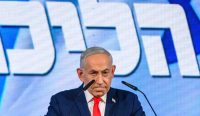 Perdana Menteri Benjamin Netanyahu berdiri di mimbar pidato dengan latar belakang layar biru usai koalisinya gagal mengamankan kursi mayoritas dalam Pemilu Israel. Partai Likud mengklaim tanpa bukti bahwa partai Arab mencuri suara pemilu. (Foto: Alexi J Rosenfeld/Getty Images)